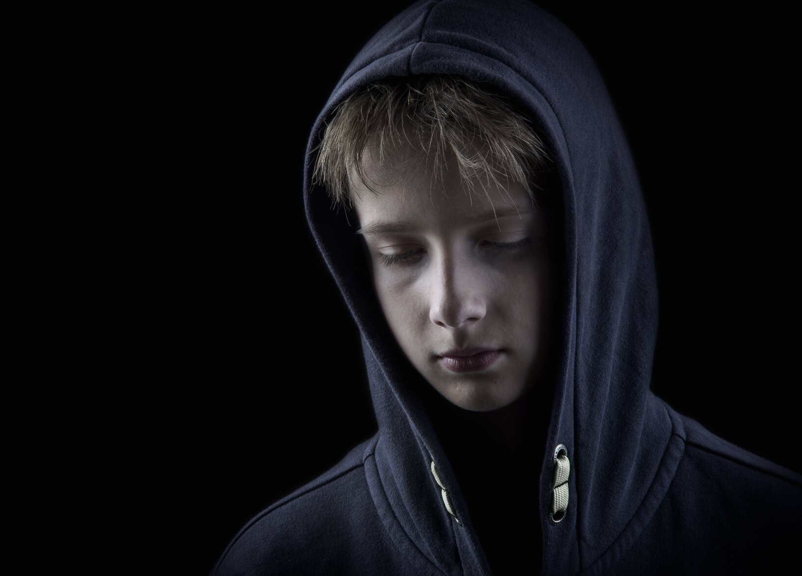 isolated teenager boy on black backgrond